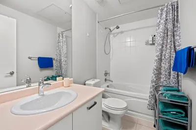 a bathroom with a sink and a toilet and a tub at Attractive 1 Bedroom High Floor with Skyline View in Toronto
