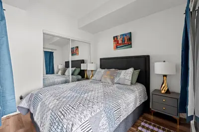 a bedroom with a bed and a large mirror at Attractive 1 Bedroom High Floor with Skyline View in Toronto