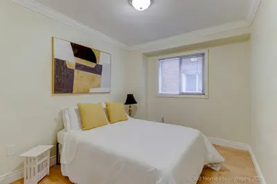 a white bedroom with a white bed and a window at Prestige Manor, 6BR with Sunroom and 3400 Sqft by Instant Suites in Mississauga