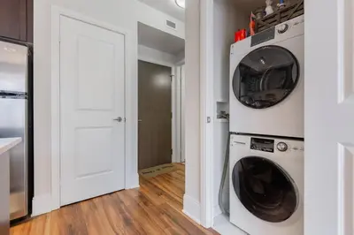 a laundry room with a washer and dryer at Modern Down Town Condo Near CN Tower with Fast WiFi in Toronto