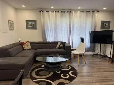 a living room with a couch and a table at Comfortable waterfront vacation Keswick in Georgina