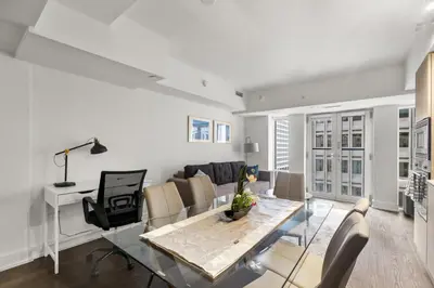 a living room with a table and a couch at Modern 1Bd & Den in Downtown Toronto in Toronto