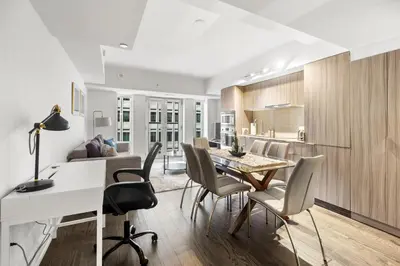 a kitchen and dining room with a table and chairs at Modern 1Bd & Den in Downtown Toronto in Toronto