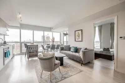 a living room with a couch and a table at Panoramic view Condo 2 BR 2 BA Free parking in Toronto
