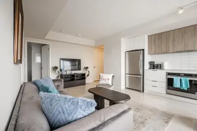 a living room with a couch and a table at Panoramic view Condo 2 BR 2 BA Free parking in Toronto