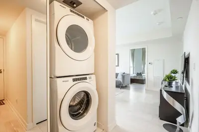 a laundry room with a washer and dryer at Panoramic view Condo 2 BR 2 BA Free parking in Toronto