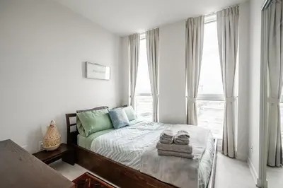 a bedroom with a bed with towels on it at Panoramic view Condo 2 BR 2 BA Free parking in Toronto