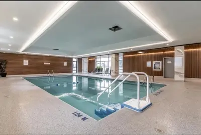 a large swimming pool in a large room with at DT Apt great view whit garden in Toronto