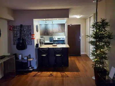 a kitchen with a counter and a stove top oven at DT Apt great view whit garden in Toronto