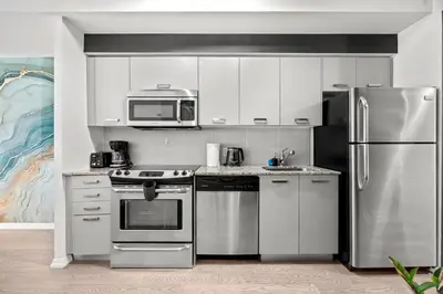 a kitchen with stainless steel appliances and a microwave at Premium 1 Bedroom with City View in Toronto