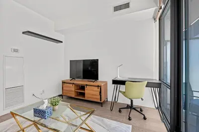 a living room with a desk and a television at Premium 1 Bedroom with City View in Toronto