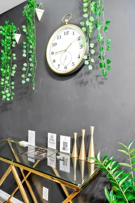 a clock hanging on a wall next to a table at Premium 1 Bedroom with City View in Toronto