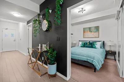 a bedroom with a bed and a black wall at Premium 1 Bedroom with City View in Toronto