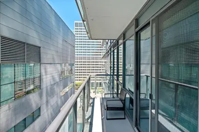 a balcony of an office building with two chairs at Premium 1 Bedroom with City View in Toronto