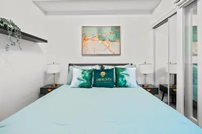 a bedroom with a large bed with blue pillows at Premium 1 Bedroom with City View in Toronto