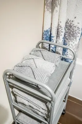 a towel rack with towels on it next to a curtain at Stylish 2 BR & Den 2BA with Free Parking in Toronto