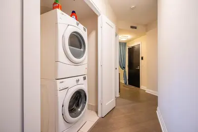 a laundry room with a washer and dryer at Stylish 2 BR & Den 2BA with Free Parking in Toronto