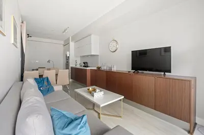 a living room with a couch and a tv at High Floor 1 Bedroom plus Den Condo Iceboat Terrace Downtown Toronto in Toronto