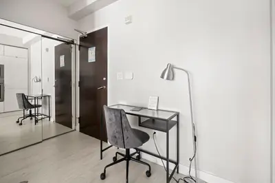 an office with a desk and chairs and a mirror at High Floor 1 Bedroom plus Den Condo Iceboat Terrace Downtown Toronto in Toronto