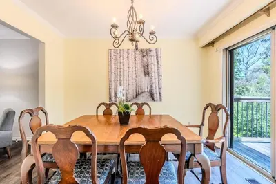 a dining room with a wooden table and chairs at Family-Friendly 2BR - Sleeps 6 in Hamilton