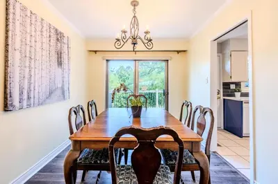 a dining room with a wooden table and chairs at Family-Friendly 2BR - Sleeps 6 in Hamilton