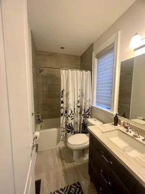 a bathroom with a toilet and a sink and a shower at Secret Garden in Nobleton