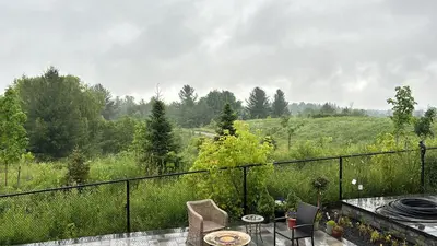 a patio with a table and chairs on a balcony at Secret Garden in Nobleton