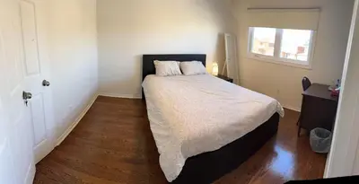 a bedroom with a large bed with a wooden floor at Bright private single bedroom V02 on second floor in Mississauga