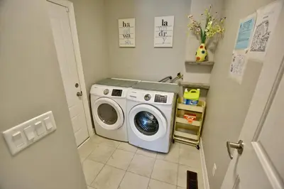 a laundry room with a washing machine in it at Blue Mountain Village Townhome 4 Bedroom with Shuttle & Pool in Blue Mountains