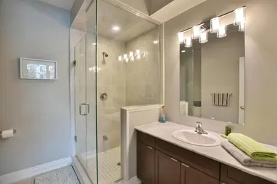 a bathroom with a sink and a glass shower at Blue Mountain Village Townhome 4 Bedroom with Shuttle & Pool in Blue Mountains
