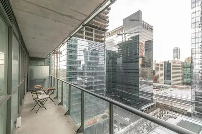 a balcony with a view of a city at Classic 1BR & Den Apartment in Downtown Gym Pool in Toronto