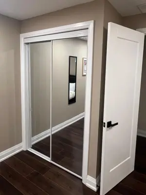 a sliding glass door in a room with wood floors at Bright & Cozy Bankfield Stay in Toronto