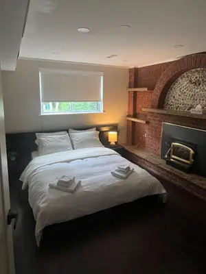 a bedroom with a large bed with towels on it at Bright & Cozy Bankfield Stay in Toronto