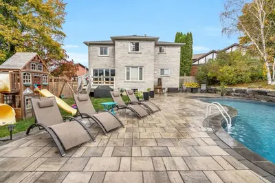 a backyard with a pool and chairs and a slide at Backyard Oasis in Bradford