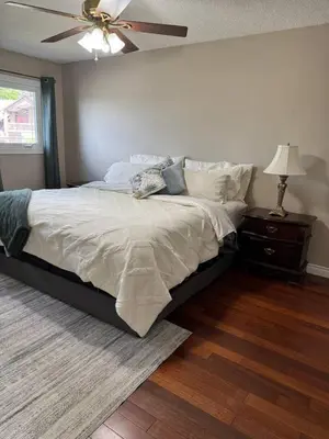 a bedroom with a bed and a ceiling fan at Backyard Oasis in Bradford
