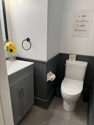 a bathroom with a white toilet and a sink at Backyard Oasis in Bradford