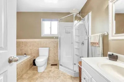 a bathroom with a toilet and a shower and a sink at Backyard Oasis in Bradford