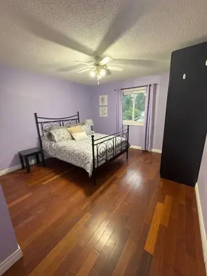 a bedroom with a bed and a ceiling fan at Backyard Oasis in Bradford