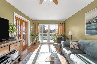 a living room with a couch and a tv at Backyard Oasis in Bradford
