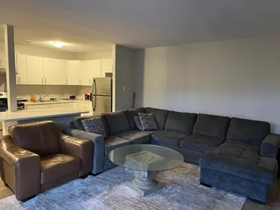 a living room with a couch and a table at Modern Suite, 1 Guest Room in St. Catharines