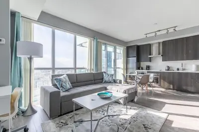 a living room with a couch and a table at 1 Bedroom 26 Floor DT near CN Tower in Toronto