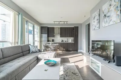a living room with a couch and a table at 1 Bedroom 26 Floor DT near CN Tower in Toronto