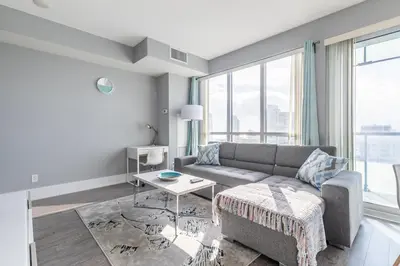 a living room with a couch and a table at 1 Bedroom 26 Floor DT near CN Tower in Toronto
