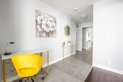 a office with a yellow chair and a desk at Sunshiny 1 BD 61st Floor Outstanding View in Toronto