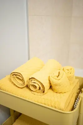 a pile of towels on a shelf in a bathroom at Sunshiny 1 BD 61st Floor Outstanding View in Toronto