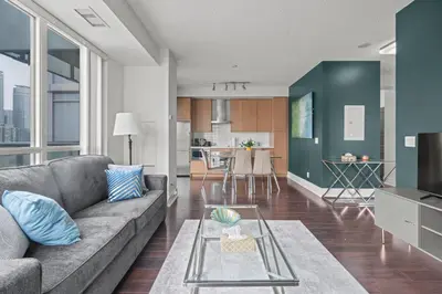 a living room with a couch and a table at Elegant 1 Bedroom in Downtown Toronto in Toronto