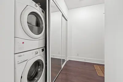 a laundry room with a washer and dryer at Elegant 1 Bedroom in Downtown Toronto in Toronto