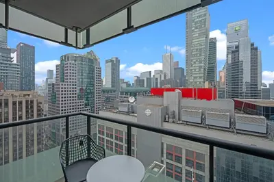 a balcony with a view of a city skyline at Elegant 1 Bedroom in Downtown Toronto in Toronto