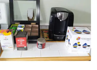a shelf with a coffee maker and boxes on it at Century House on Quarter acre lot in Acton
