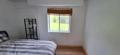 a bedroom with a bed and a window at Century House on Quarter acre lot in Acton